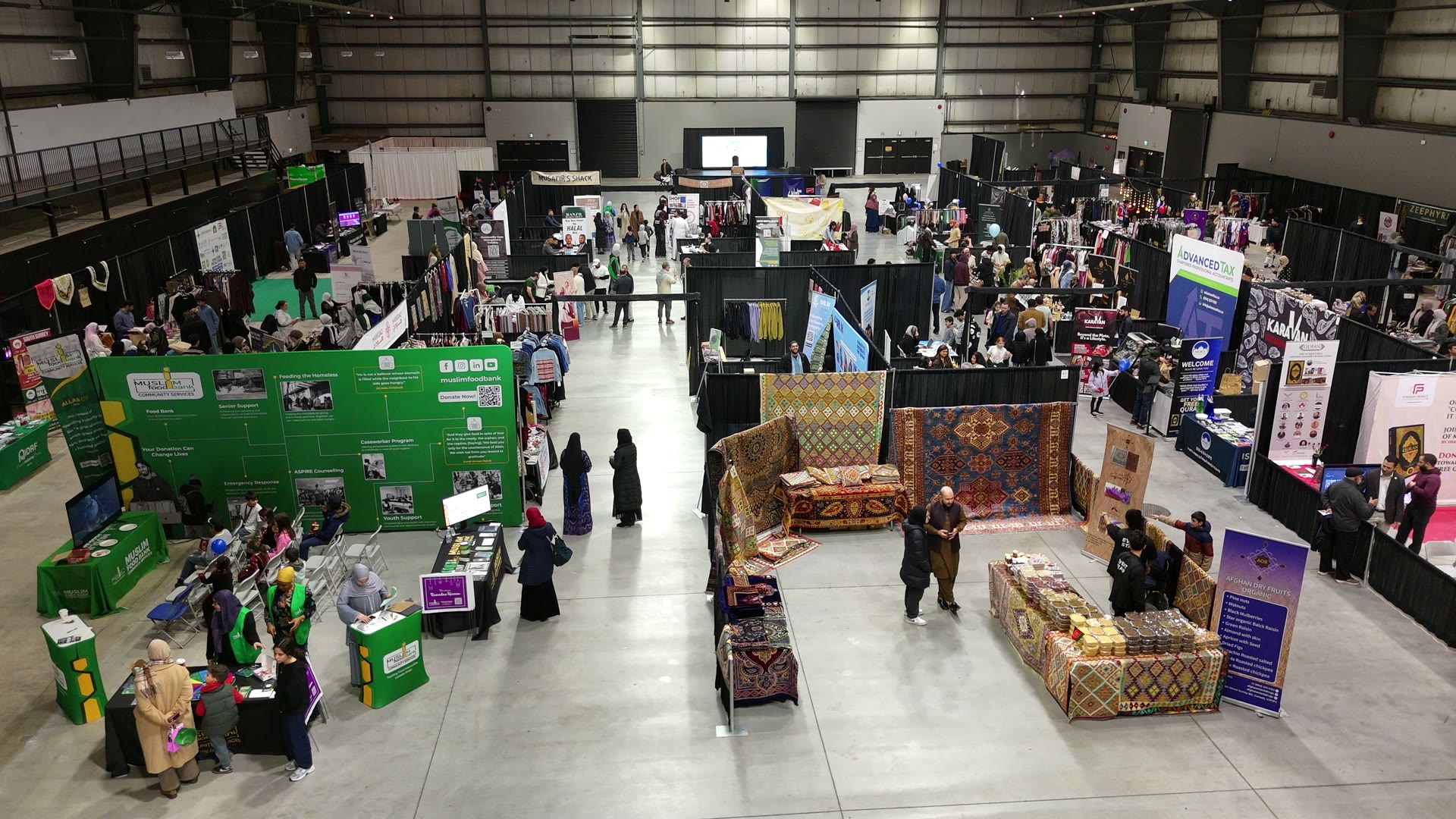 Aerial view of the packed marketplace floor with vendors and crowds